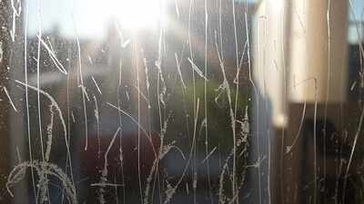 sunlit grimy window pane